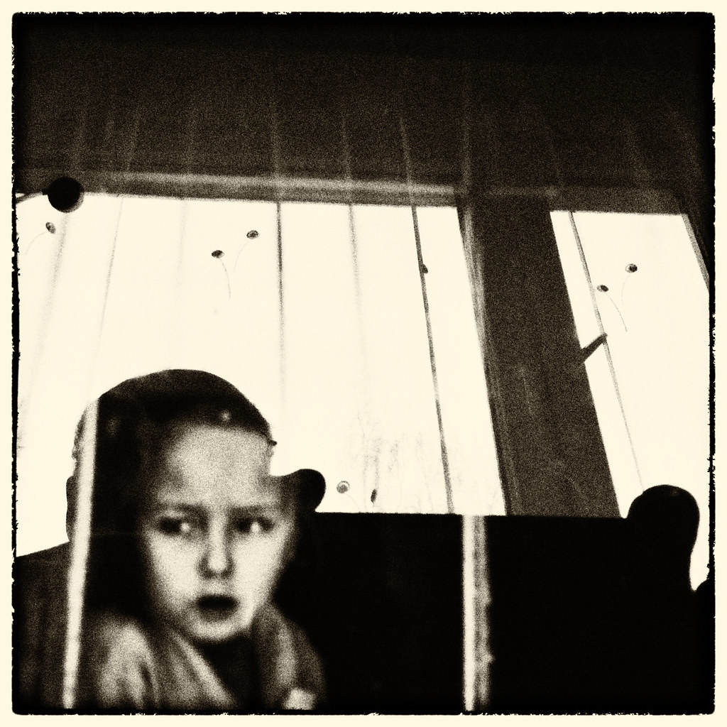 Stylized image of child looking out window
