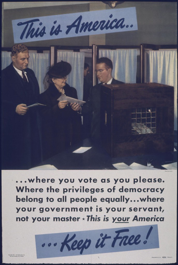 WWII era poster showing voters at a polling station, with the message: "This is America... where you vote as you please. Where the privileges of democracy belong to all people equally... where your government is your servant, not your master. This is your America... Keep it Free!"