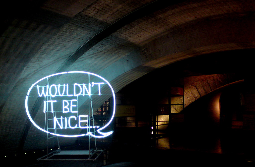 Neon speech bubble reading "Wouldn't it be nice..."