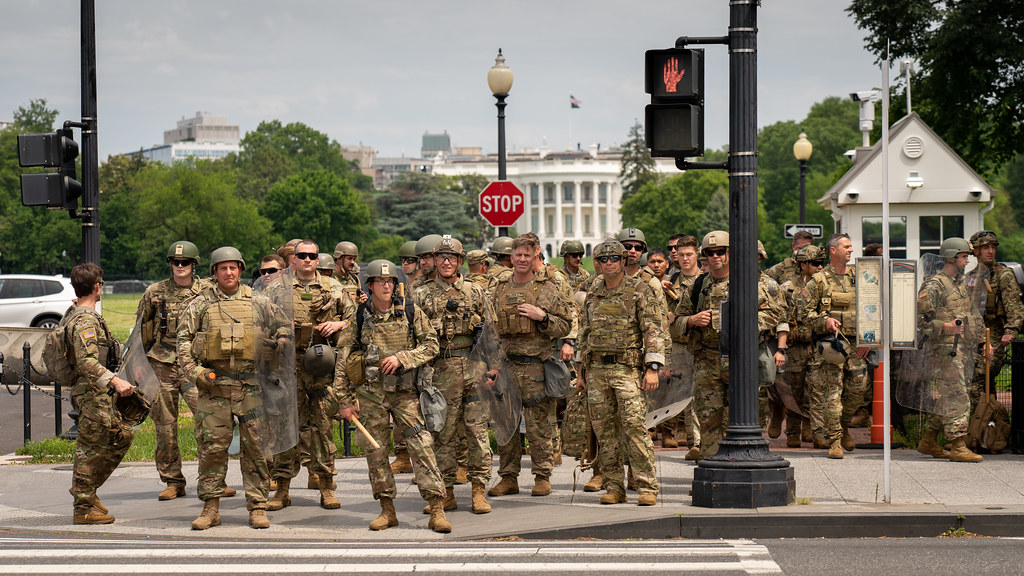 A contingent of military special forces with the White House in the background