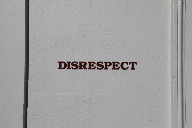 Wall with the word disrespect painted on it