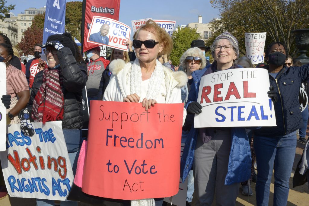 Peaceful protestors holding signs in favor of voting rights