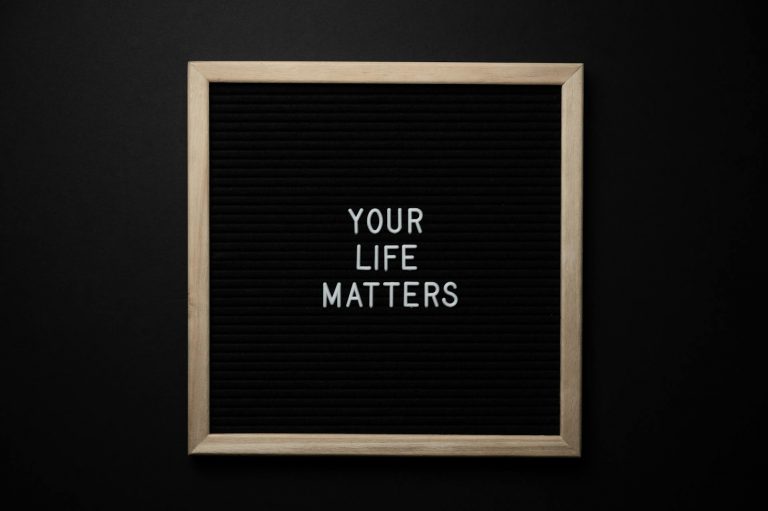 Sign with "Your Life Matters" on black background.