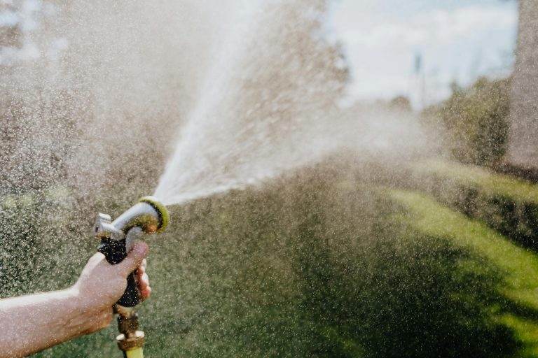 Close up photo of water coming out of a spray hose.