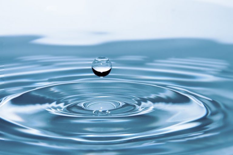 Water droplet in larger pool of water.