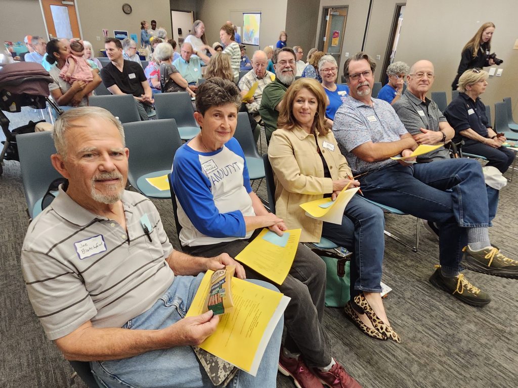 Members during a meeting sitting in chairs