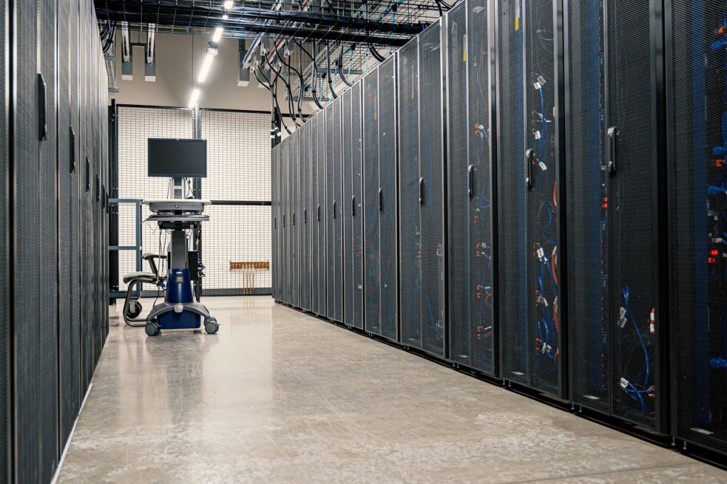 Rows of racks with servers at data center.